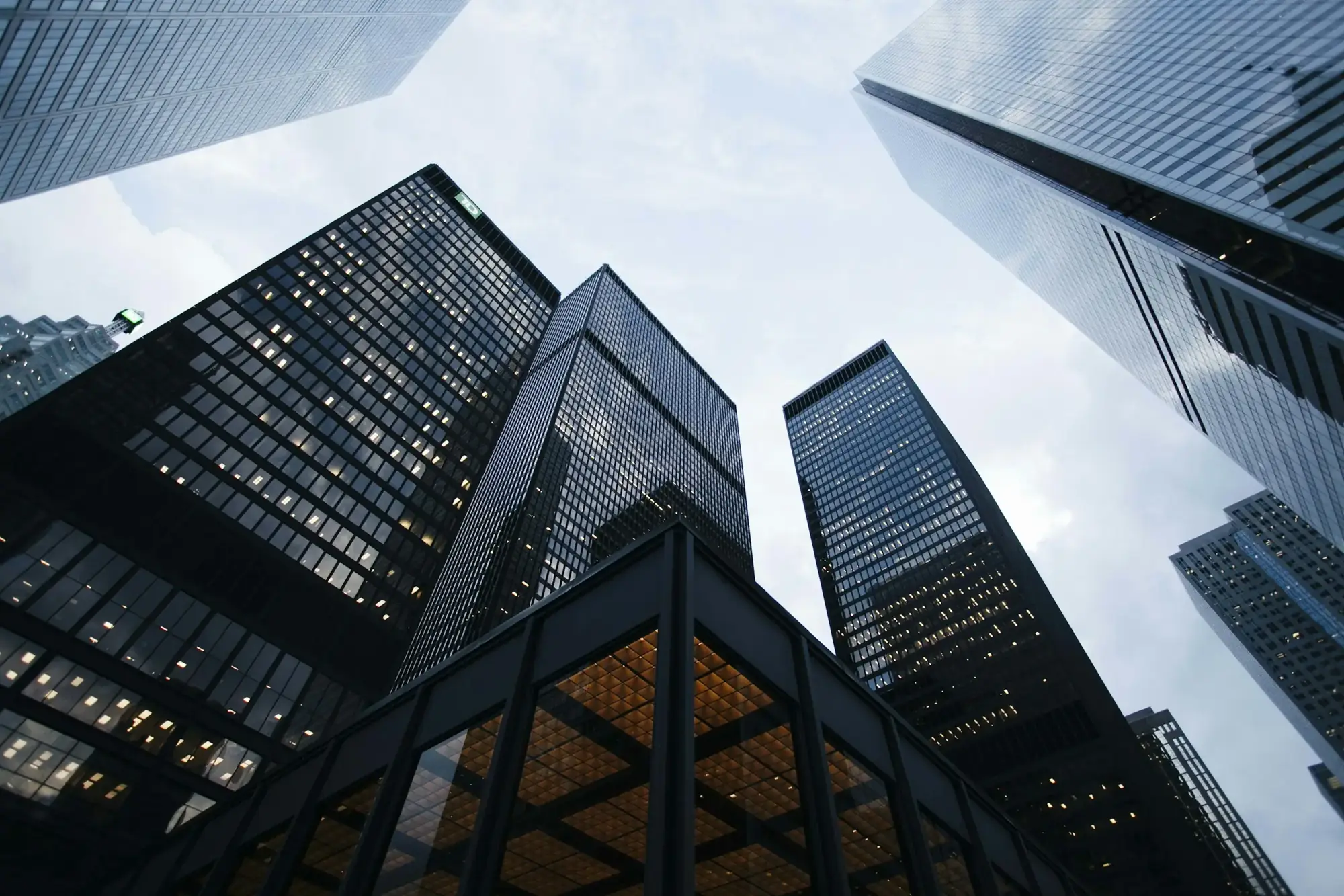 Low-angle view of glass office towers against a clear sky